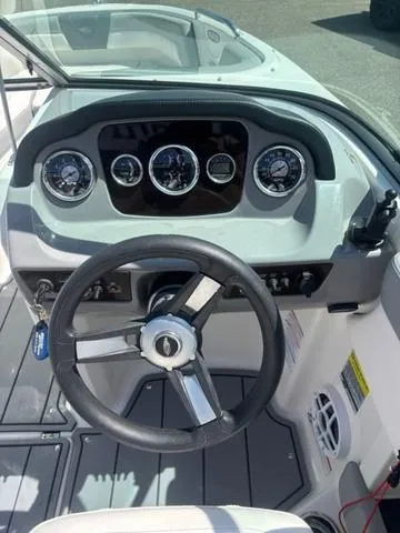 Slide: The Image of 2021 Chaparral 21 SSi boat dashboard with steering wheel and gauges. - 10