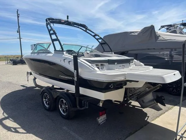 Slide: The Image of 2021 Chaparral 21 SSi boat on trailer, parked outdoors under clear sky. - 3