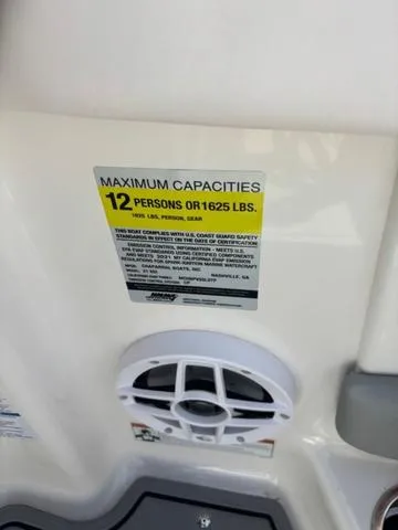 Slide: The Image of 2021 Chaparral 21 SSi boat capacity label, 12 persons or 1625 lbs, safety compliance. - 6