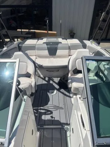 Slide: The Image of 2021 Chaparral 21 SSi boat interior with seating and windshield, showcasing modern design. - 8