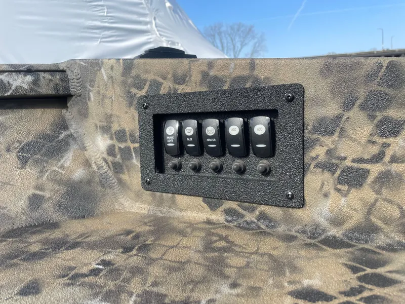 Slide: The Image of Control panel on 2025 Excel 1751 River Warrior boat with camouflage design. - 12