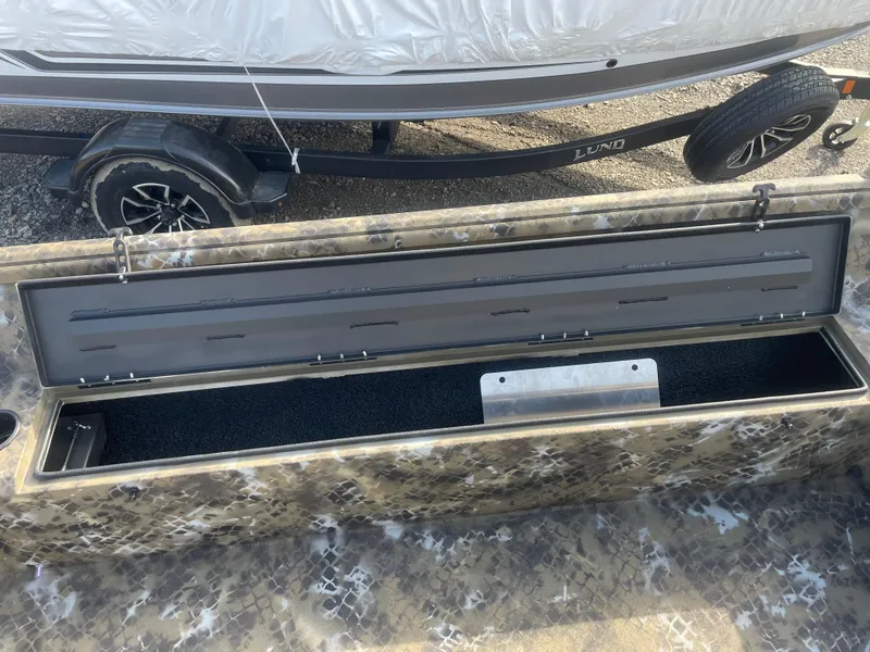 Slide: The Image of 2025 Excel 1751 River Warrior boat storage compartment open, showcasing interior space. - 14