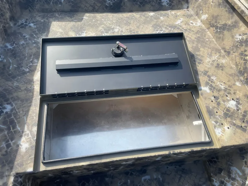 Slide: The Image of 2025 Excel 1751 River Warrior storage compartment with open lid, showcasing interior space. - 17