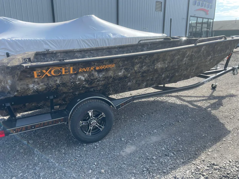 Slide: The Image of 2025 Excel 1751 River Warrior boat on trailer, camo design, parked outdoors. - 21