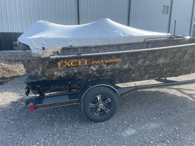 Slide: The Image of 2025 Excel 1751 River Warrior boat on trailer, covered and parked outdoors. - 22