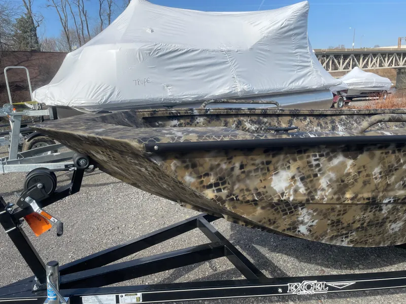 Slide: The Image of 2025 Excel 1751 River Warrior boat with camouflage design on a trailer. - 7