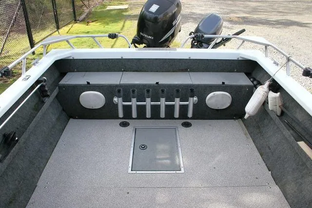 Slide: The Image of 2008 Thunder Jet 20 Luxor boat interior with rod holders and Suzuki outboard motor. - 10