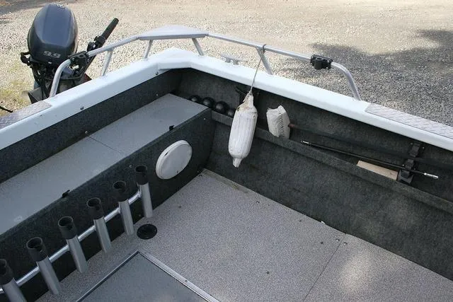 Slide: The Image of 2008 Thunder Jet 20 Luxor boat interior with motor and fishing rod holders. - 11