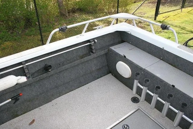 Slide: The Image of 2008 Thunder Jet 20 Luxor boat interior with rod holders and storage compartments. - 12