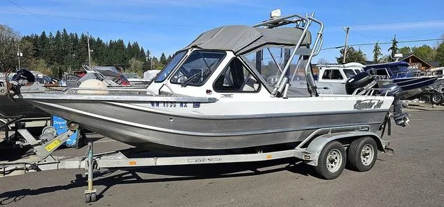 Slide: The Image of 2008 Thunder Jet 20 Luxor boat on trailer, parked outdoors under clear sky. - 14