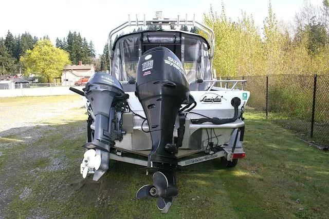 Slide: The Image of 2008 Thunder Jet 20 Luxor boat with dual outboard motors on a grassy area. - 4