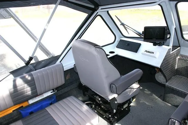 Slide: The Image of 2008 Thunder Jet 20 Luxor boat interior with seating and navigation equipment. - 7