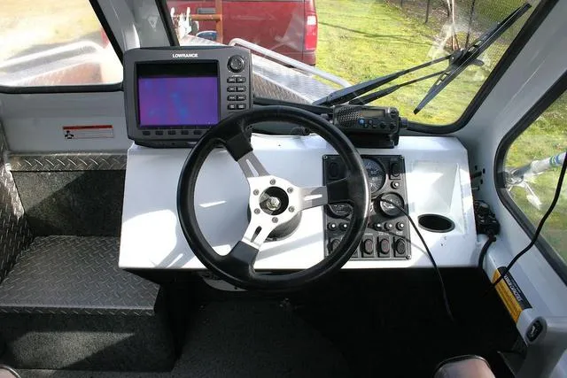 Slide: The Image of 2008 Thunder Jet 20 Luxor boat dashboard with steering wheel and navigation equipment. - 8