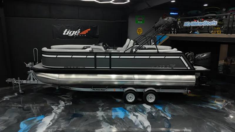 Slide: The Image of 2025 Viaggio Lago X-U pontoon boat on trailer in showroom. - 1
