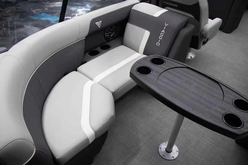 Slide: The Image of 2025 Viaggio Lago X-U boat interior with gray seating and table featuring cup holders. - 11