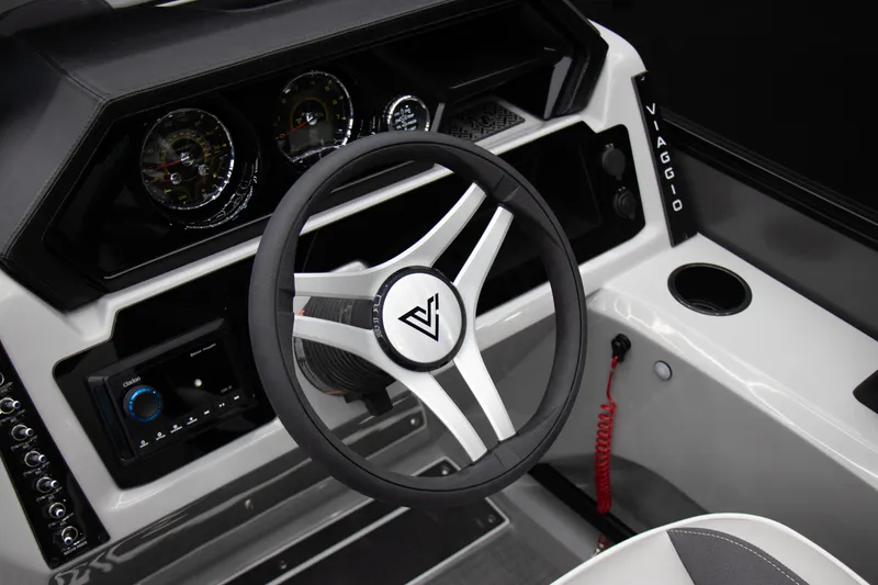 Slide: The Image of 2025 Viaggio Lago X-U boat dashboard with steering wheel and control panel. - 2