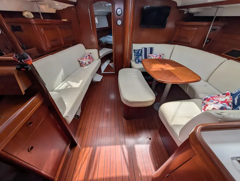 Slide: The Image of Luxurious interior of 2003 Beneteau Oceanis 473 sailboat with elegant wood finish and cozy seating. - 3