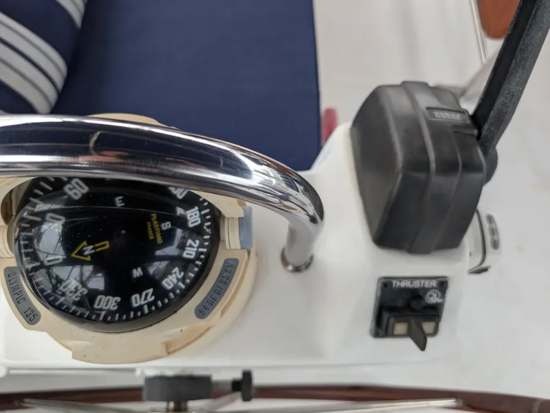 Slide: The Image of Compass and thruster controls on a 2003 Beneteau Oceanis 473 sailboat. - 35
