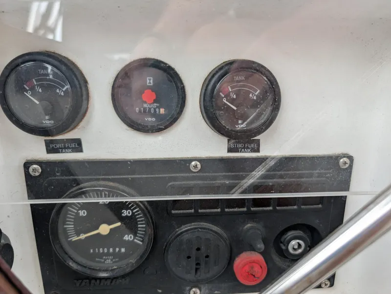 Slide: The Image of Control panel of a 2003 Beneteau Oceanis 473 sailboat, showing fuel gauges and engine indicators. - 44