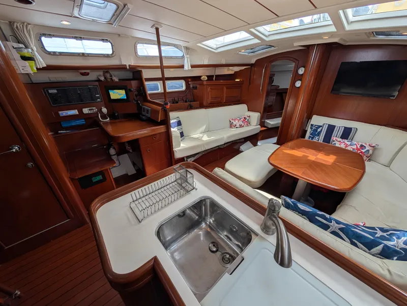 Slide: The Image of Interior of 2003 Beneteau Oceanis 473 yacht with modern kitchen and cozy seating area. - 6