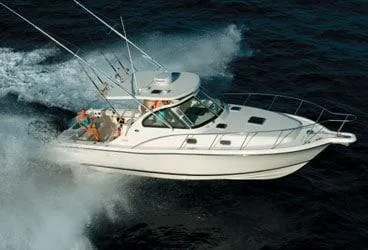 Slide: The Image of 2007 Pursuit 335 Offshore boat cruising on open water, creating a dynamic wake. - 0