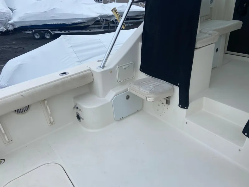 Slide: The Image of 2007 Pursuit 335 Offshore boat interior with seating and storage compartments. - 13