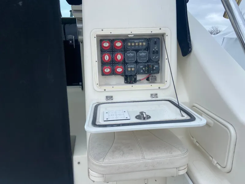 Slide: The Image of Control panel on a 2007 Pursuit 335 Offshore boat, featuring switches and seating. - 14