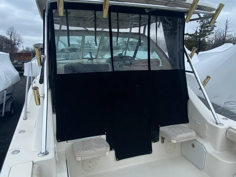 Slide: The Image of 2007 Pursuit 335 Offshore boat with covered cockpit and rod holders. - 15