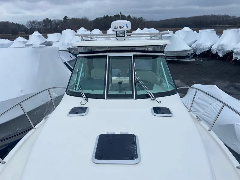 Slide: The Image of 2007 Pursuit 335 Offshore boat with Garmin radar, docked among covered boats. - 18