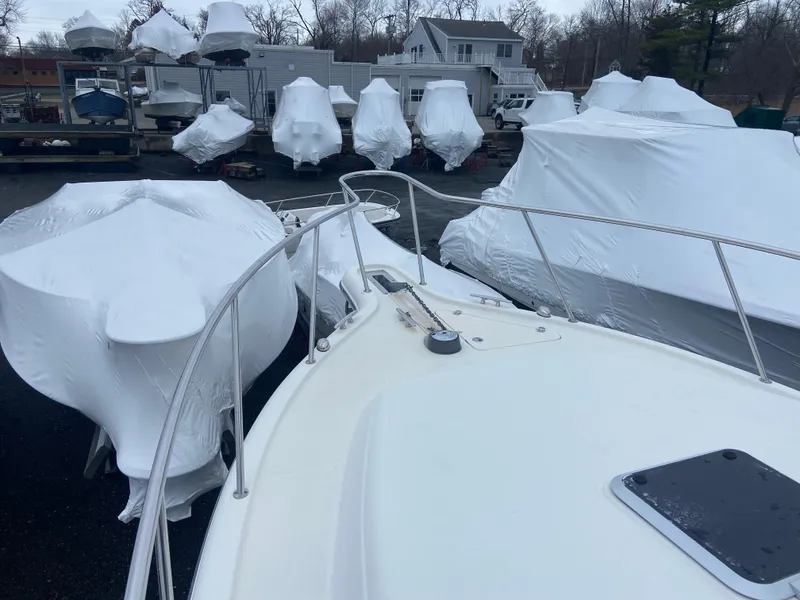 Slide: The Image of 2007 Pursuit 335 Offshore boat in storage, surrounded by shrink-wrapped vessels. - 19