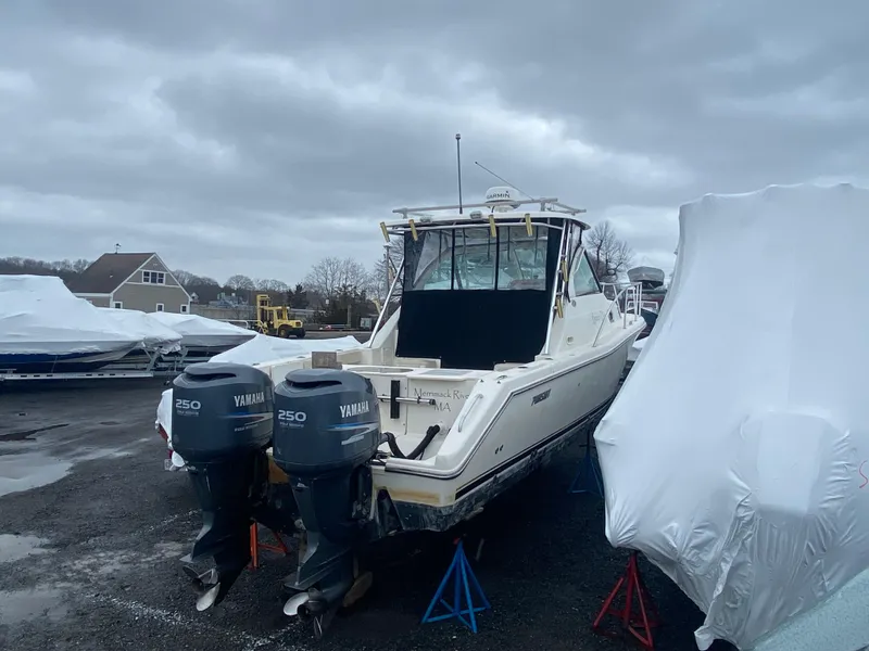 Slide: The Image of 2007 Pursuit 335 Offshore boat with twin Yamaha 250 engines, stored outdoors. - 2