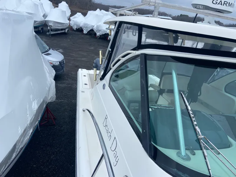 Slide: The Image of 2007 Pursuit 335 Offshore boat in storage, surrounded by covered vehicles. - 21