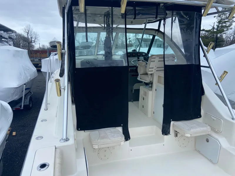 Slide: The Image of 2007 Pursuit 335 Offshore boat with covered cockpit and seating area. - 22