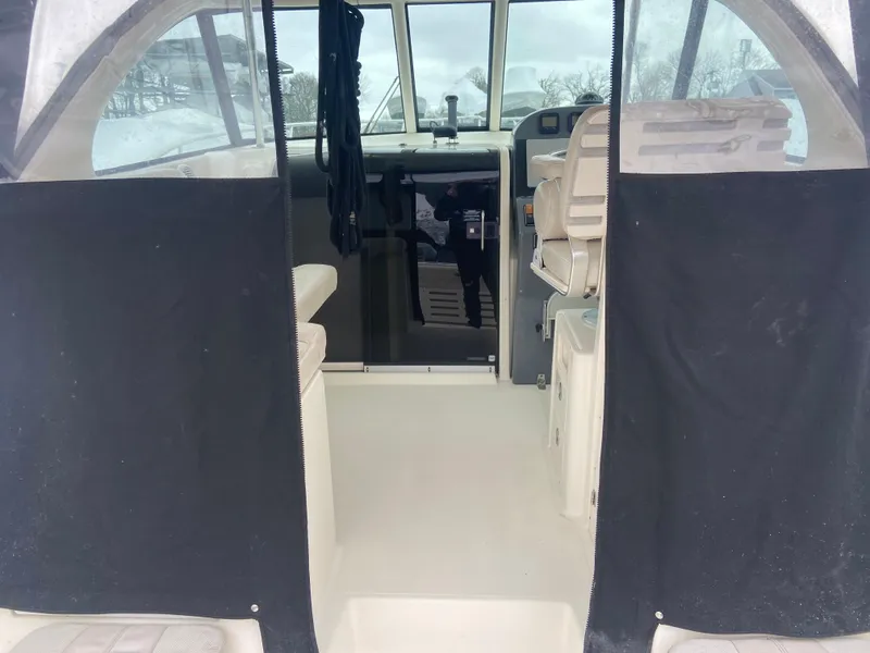 Slide: The Image of 2007 Pursuit 335 Offshore boat interior with seating and helm. - 23