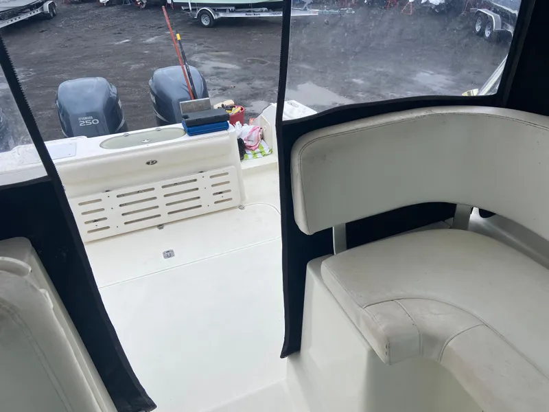 Slide: The Image of 2007 Pursuit 335 Offshore boat interior with seating and dual outboard motors. - 25