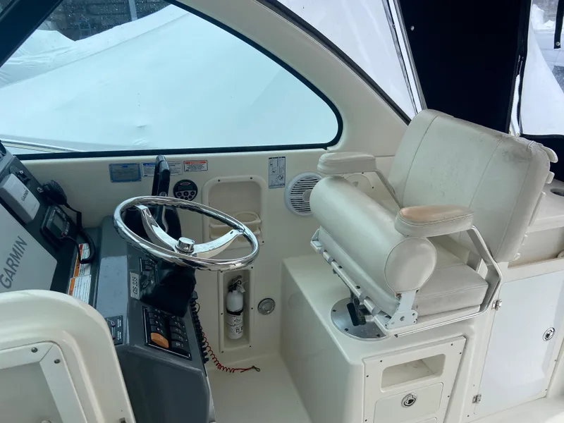 Slide: The Image of 2007 Pursuit 335 Offshore boat cockpit with steering wheel and captain's chair. - 27