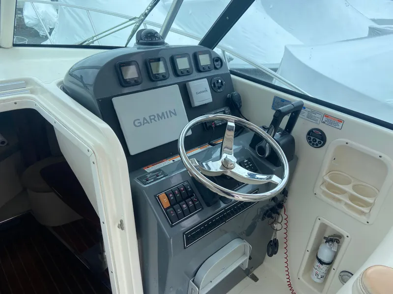 Slide: The Image of 2007 Pursuit 335 Offshore boat helm with Garmin navigation system and steering wheel. - 28