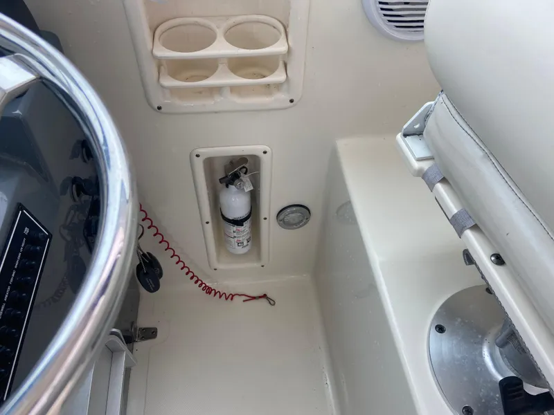 Slide: The Image of 2007 Pursuit 335 Offshore boat interior with fire extinguisher and cup holders. - 31