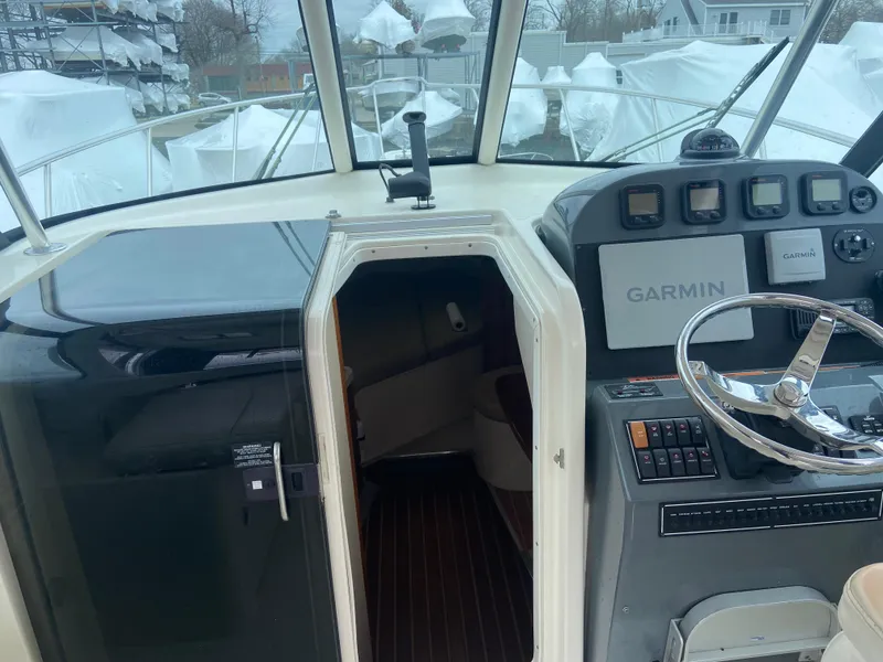 Slide: The Image of 2007 Pursuit 335 Offshore boat cockpit with Garmin navigation system and cabin entrance. - 33