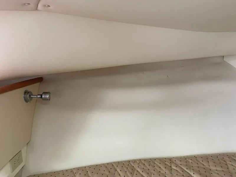 Slide: The Image of Interior cabin view of a 2007 Pursuit 335 Offshore boat, featuring a cushioned seating area. - 39