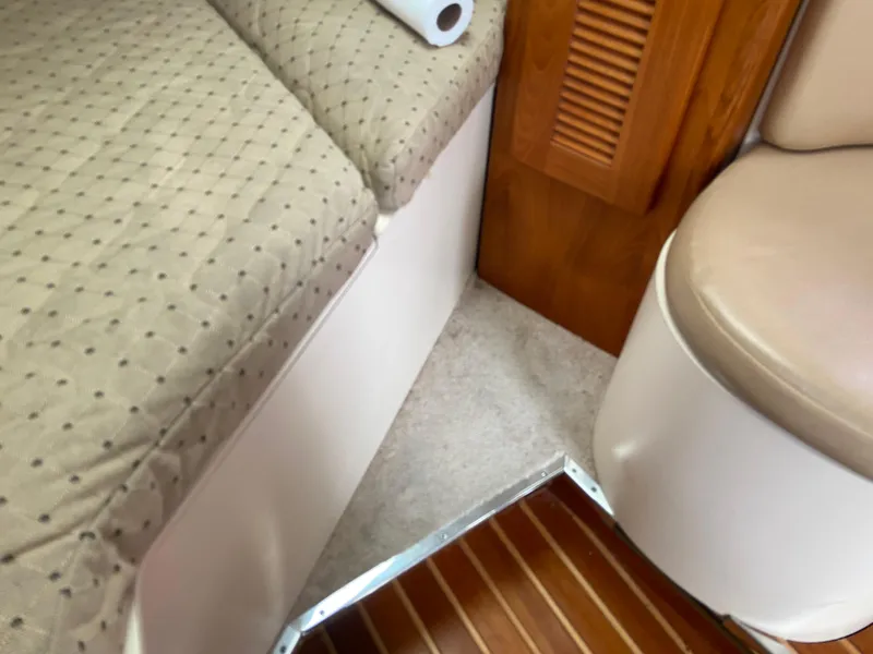 Slide: The Image of Interior of 2007 Pursuit 335 Offshore boat with cushioned seating and wooden accents. - 42