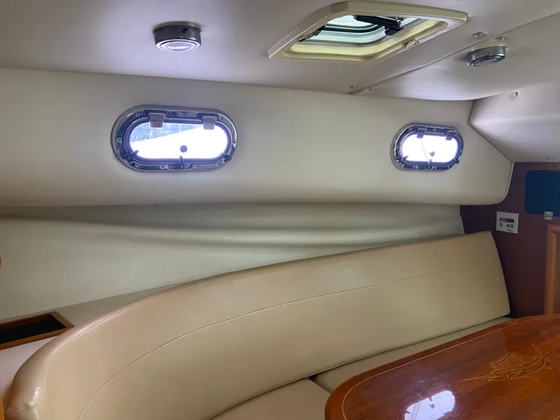 Slide: The Image of Interior of 2007 Pursuit 335 Offshore boat with portholes and seating area. - 44