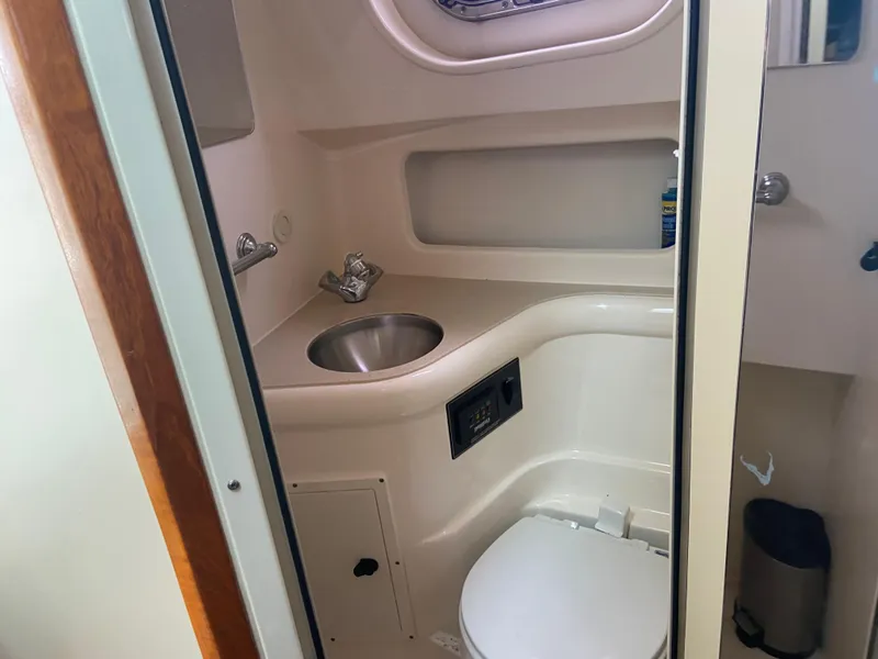 Slide: The Image of 2007 Pursuit 335 Offshore boat bathroom with sink and toilet. - 49