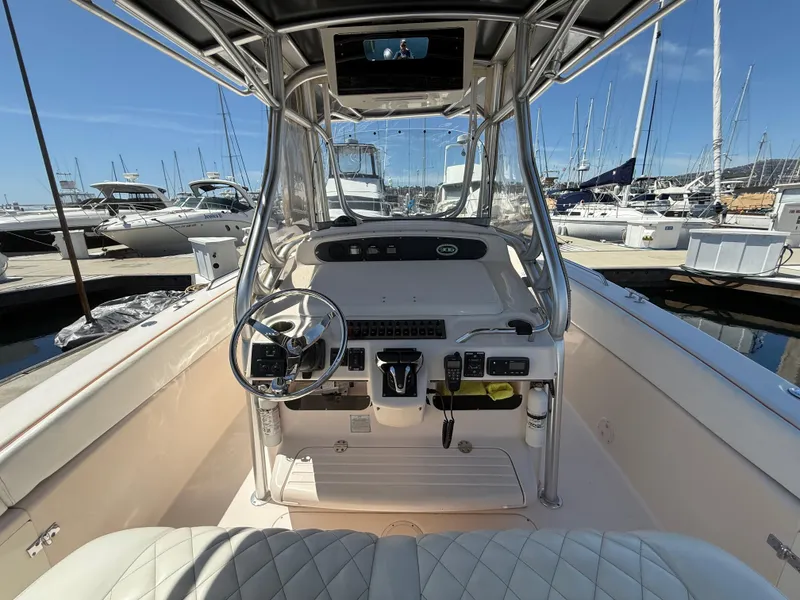 Slide: The Image of 2005 Grady-White Bimini 306 boat interior with steering wheel, docked at marina. - 10