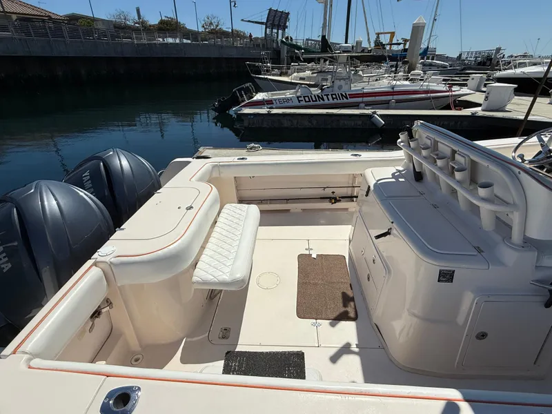 Slide: The Image of 2005 Grady-White Bimini 306 boat interior at marina, featuring seating and storage. - 15