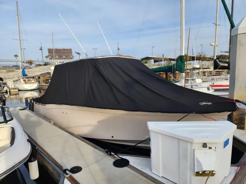 Slide: The Image of 2005 Grady-White Bimini 306 boat covered at marina dock. - 19