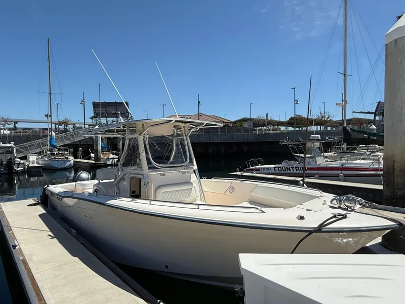 Slide: The Image of 2005 Grady-White Bimini 306 boat docked at marina under clear blue sky. - 2