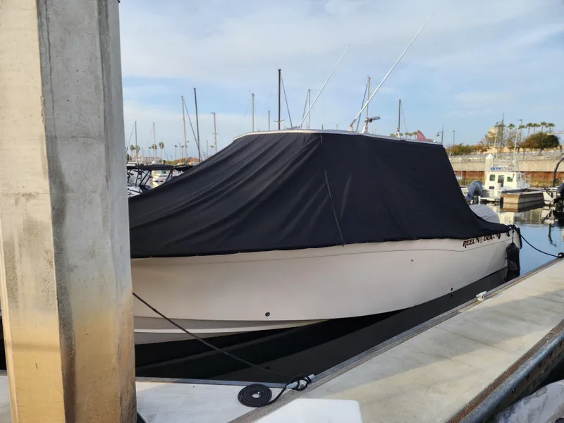 Slide: The Image of 2005 Grady-White Bimini 306 boat covered at marina dock. - 20