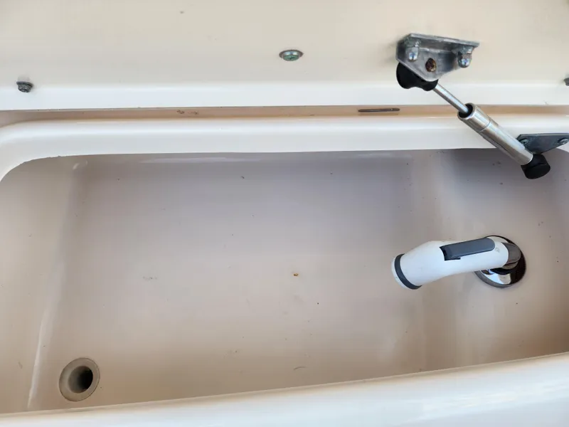 Slide: The Image of Livewell compartment of 2005 Grady-White Bimini 306 boat, featuring drainage and hydraulic support. - 24
