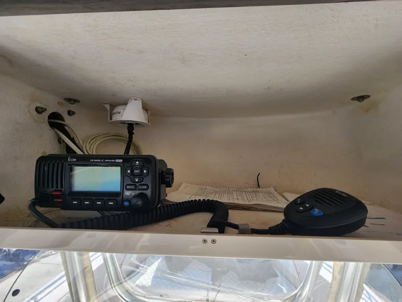 Slide: The Image of 2005 Grady-White Bimini 306 boat radio equipment in storage compartment. - 29